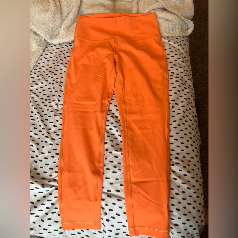 Orange cropped LuLulemon leggings.